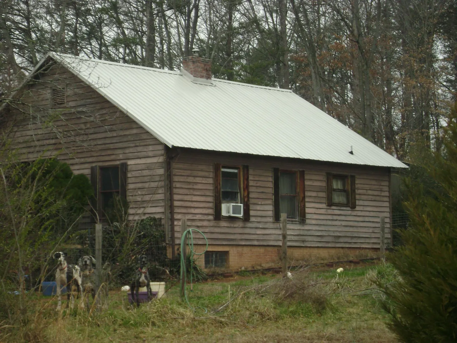 White metal roof on an old wood sided farmhouse, from a Metal Roof Installation job in Rockfall